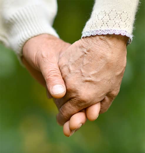 Elder Couple Holding Hands
